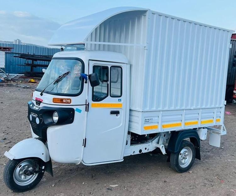 Futuristic XEV Electric Three-Wheeler Cargo auto on urban street